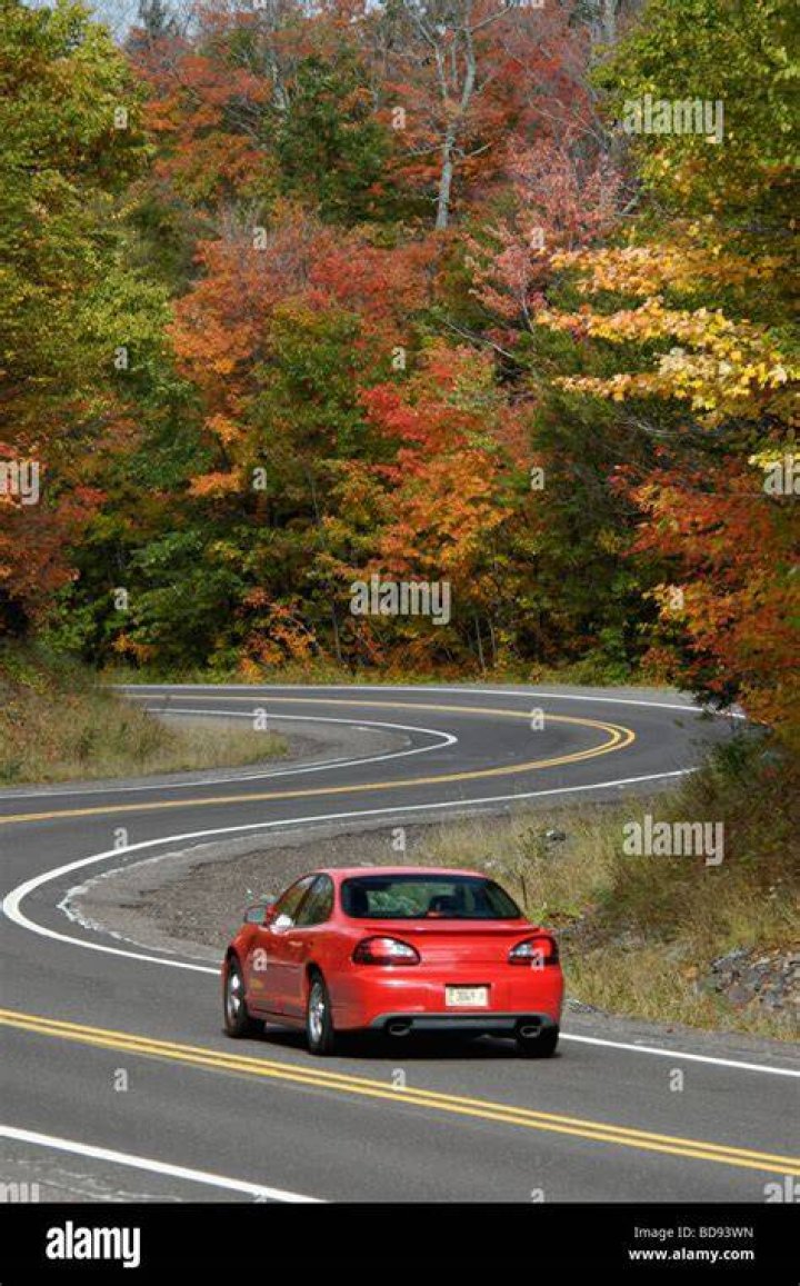 A car driving down the road in Gran Turismo 7