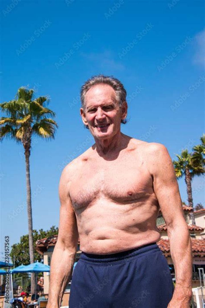 Bare-chested senior man pinching skin around waist, mid section bare chested senior man pinching skin around waist mid section