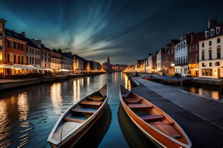 boats in water in front of colorful buildings