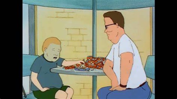 Bobby smoking at a table in The Hunger