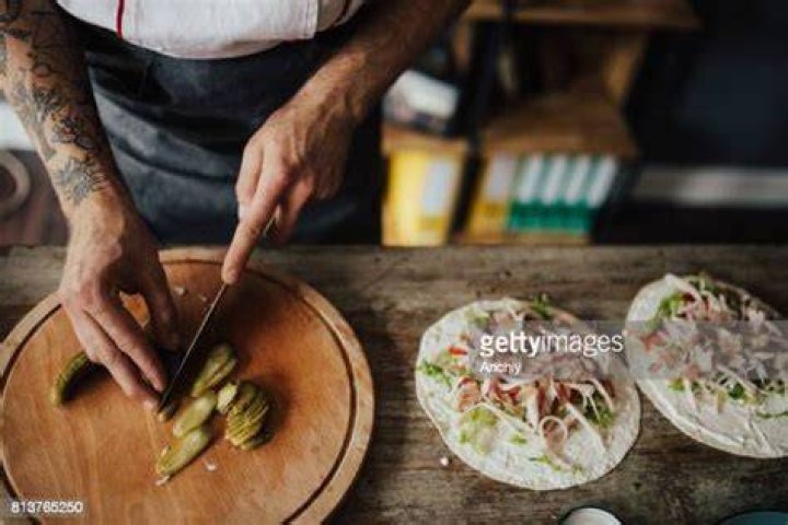 Chef cuts picles in thin slices for wrap sandwich chef cuts picles in thin slices for wrap sandwich