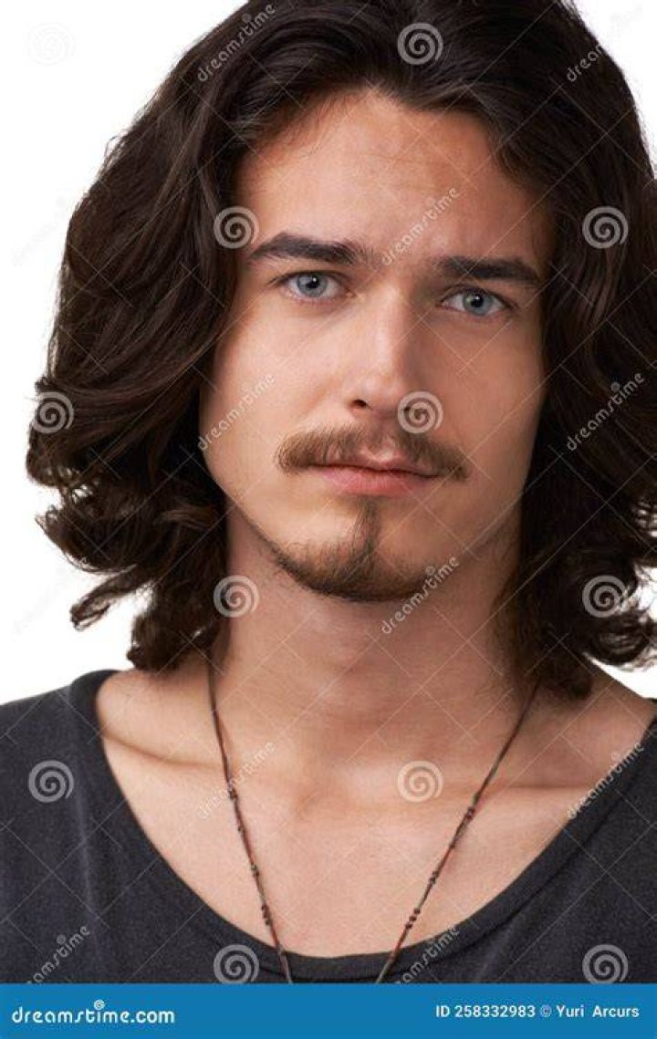 closeup of handsome man looking in mirror at home