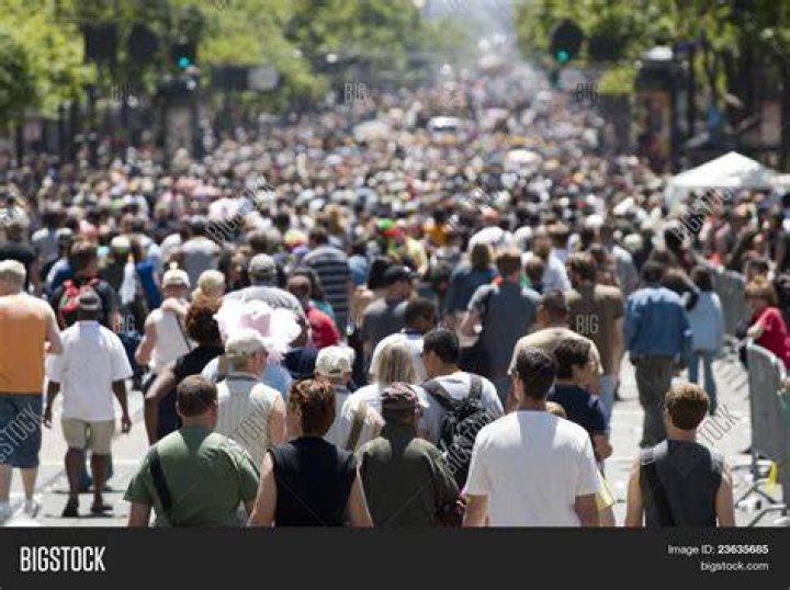 crowd of people walking on city street