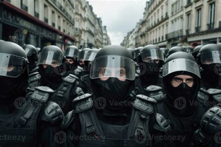 eastern europe riot police behind the fence