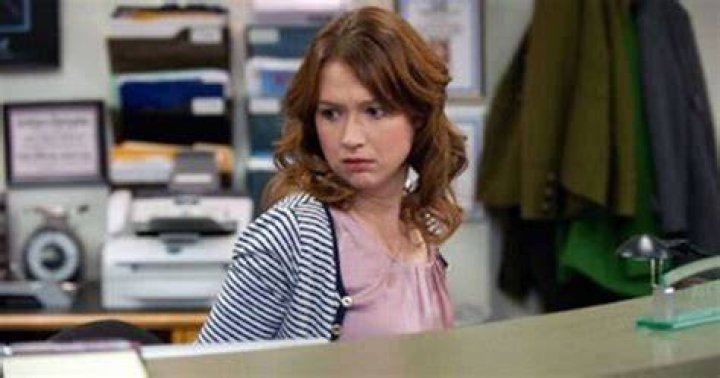Erin looks off camera while at her desk on The Office