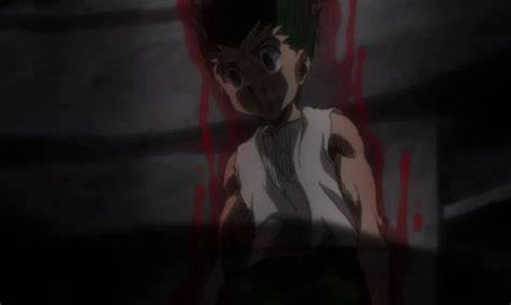 Gon surrounded by an aura while a figure floats behind him