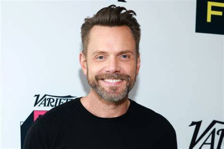 Joel McHale jumping from a paintball explosion in Community 