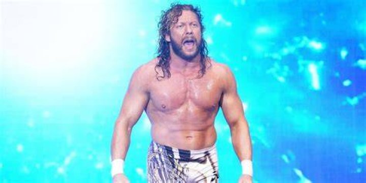 Kenny Omega with the AEW and Impact Championships