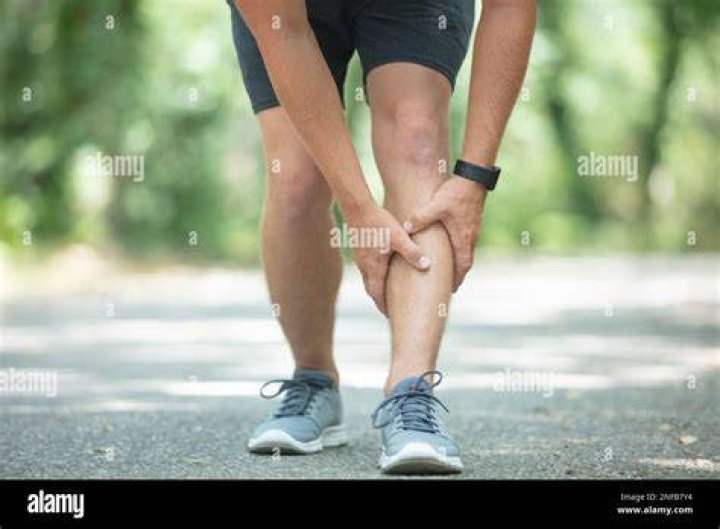 knee injury on running outdoors man holding knee by hands close up and suffering with pain sprain ligament or meniscus problem