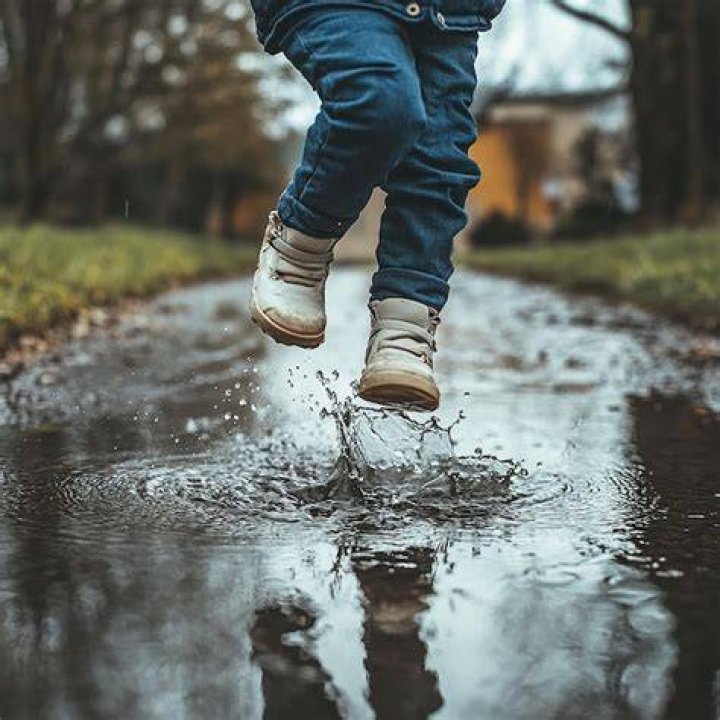 Lady jumping in a puddle Lady jumping in a puddle