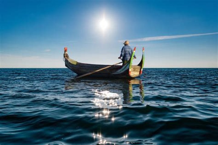 man in a boat at sunset