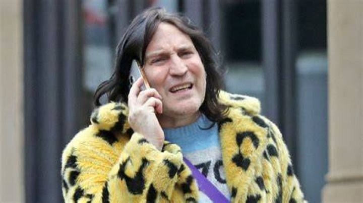 Noel Fielding posing in front of his painting