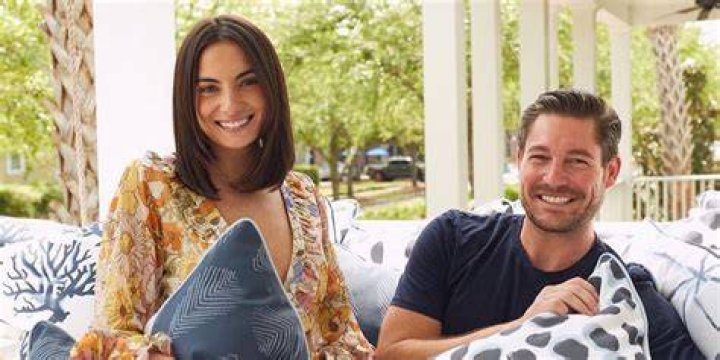 Paige and Craig posing in front of a city backdrop from Bravo