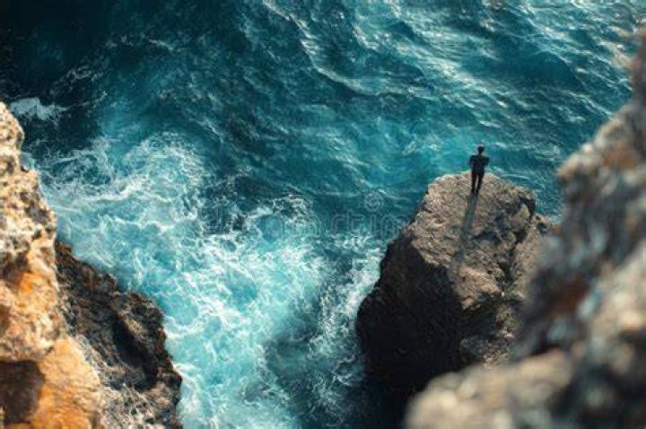person overlooking ocean in Monterosso al Mare, Italy