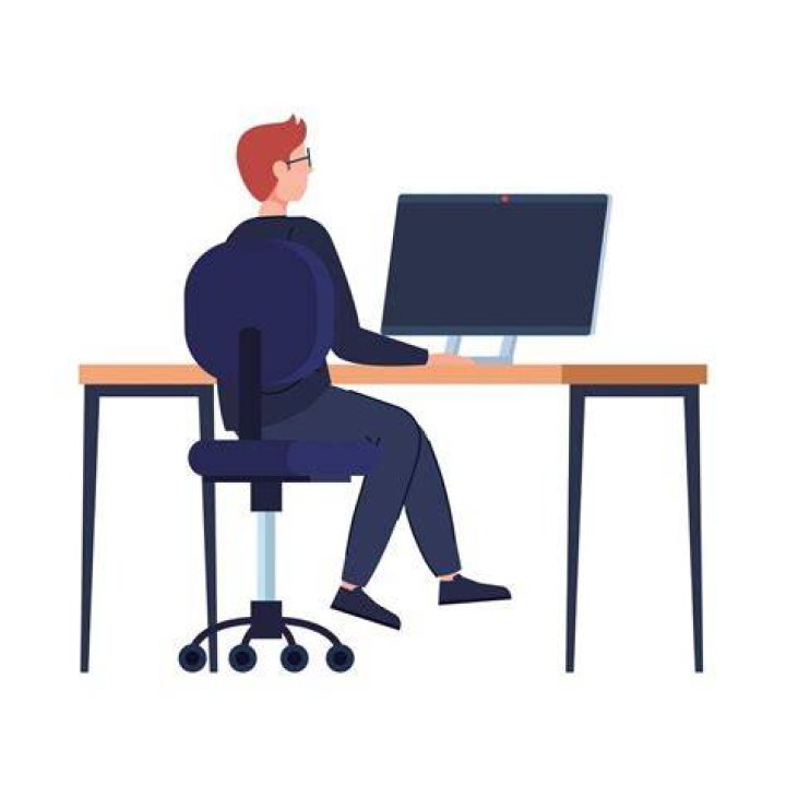 person sitting at computer with cup of coffee