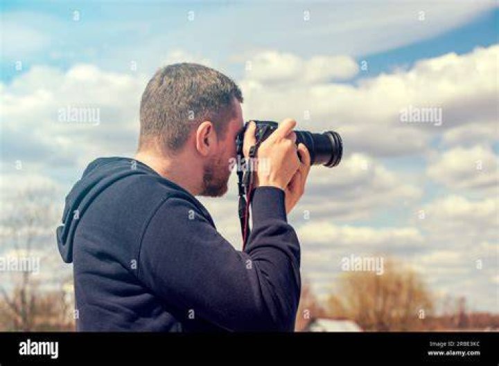 person taking a photo of a mountain in indonesia