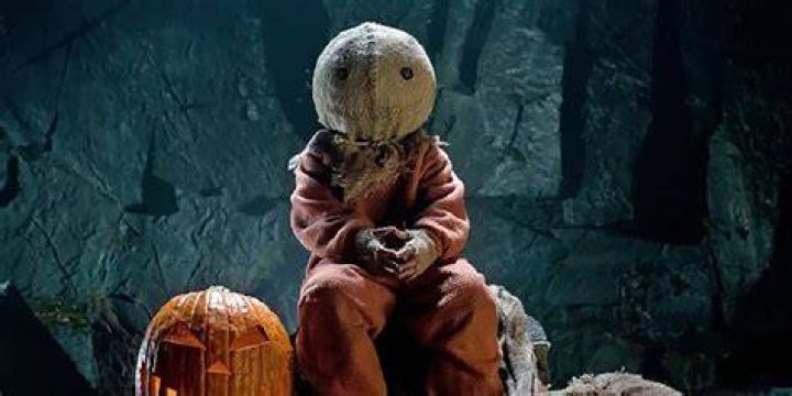 Sam sitting by a pumpkin in Trick 'r Treat.