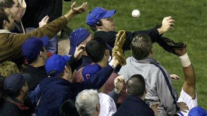 Steve Bartman reaches for a foul ball in the cover image for Catching Hell