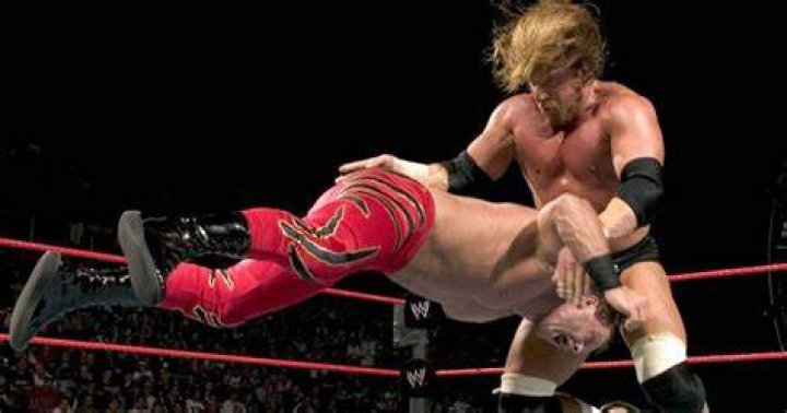 Triple H with the pedigree on The Rock in WWE