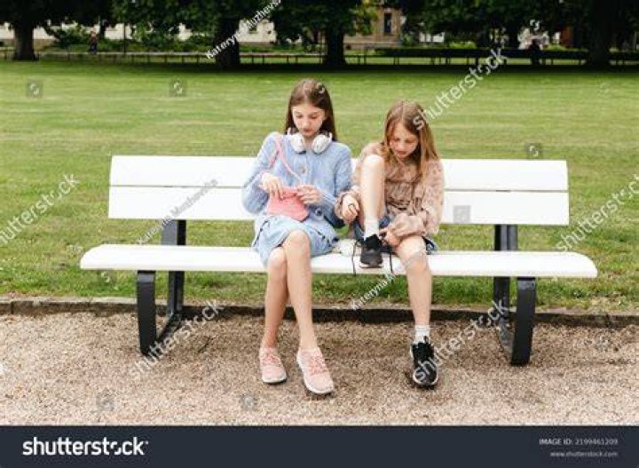 two girls sitting on a bench two girls sitting on a bench