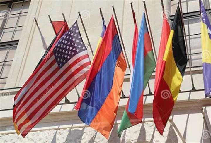 white building with colorful flags