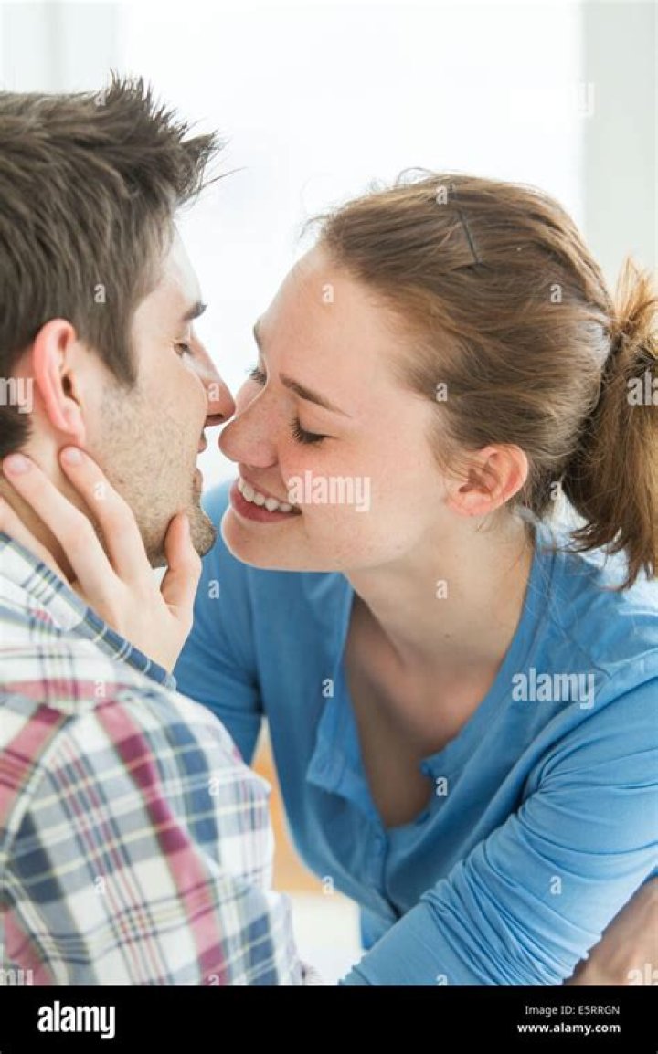 woman kissing young man woman kissing young man