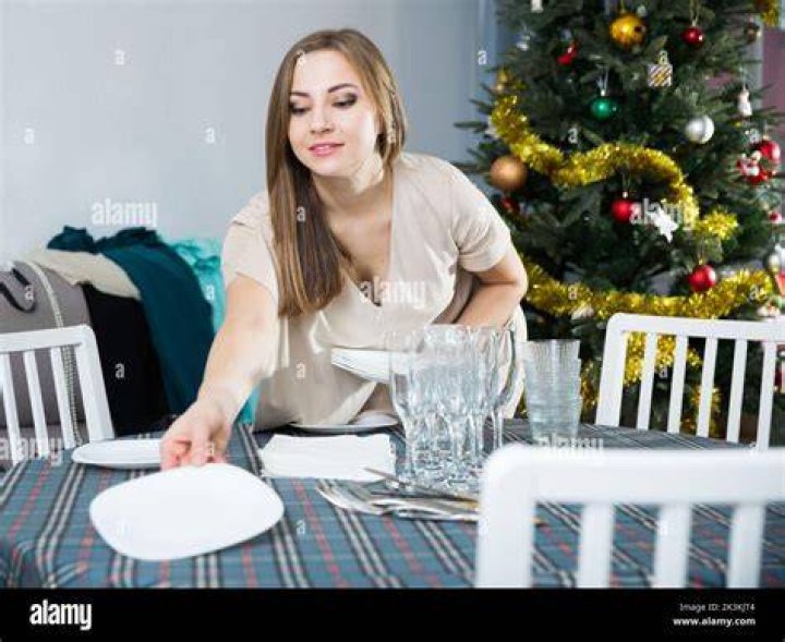 woman setting up table for dinner party