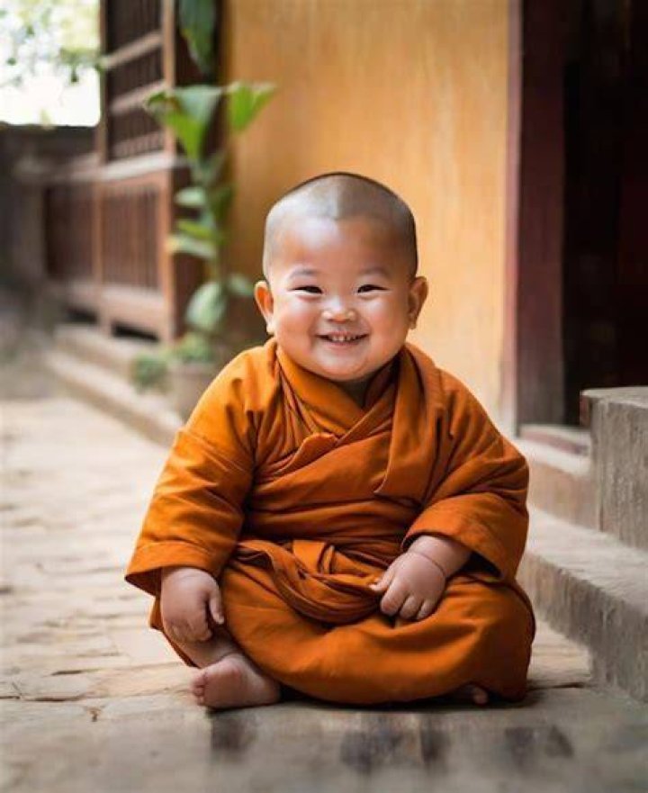young monk studying and smiling